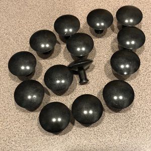 Fourteen (14) dark metal drawer pulls